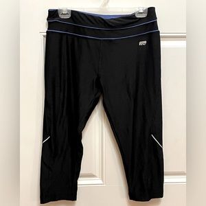 Marika Large black Capris with royal blue stripes at waistline.